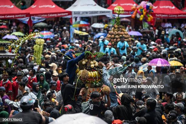 People reach out to claim free durians during the durian festival in Wonosalam village in Jombang, eastern Java Island on March 3, 2024. Grown across...