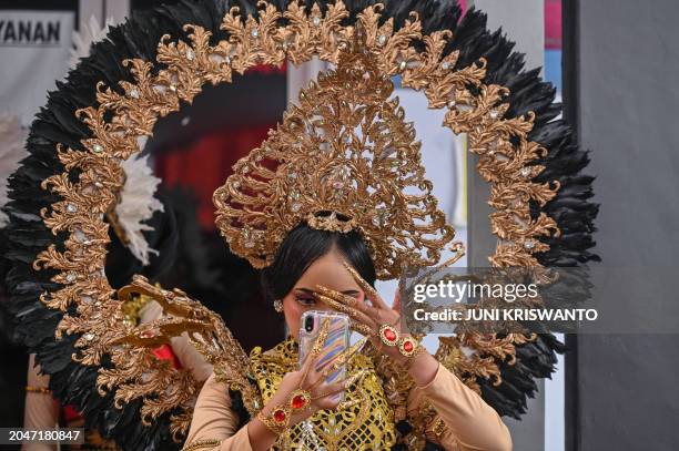 Dancer fixes her make-up during the durian festival in Wonosalam village in Jombang, eastern Java Island on March 3, 2024. Grown across tropical...