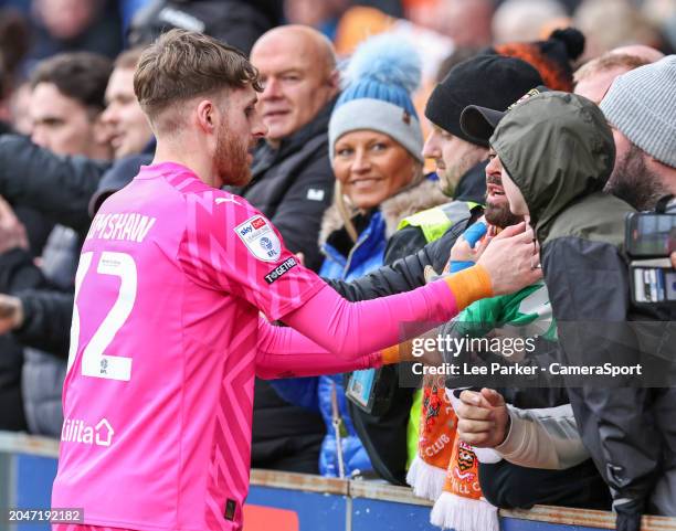 Blackpool's Daniel Grimshaw gives his gloves to a young fan at the end of the match during the Sky Bet League One match between Shrewsbury Town and...