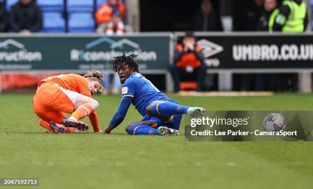 Shrewsbury Town's Tunmise Sobowale is tackled by Blackpool's Hayden Coulson during the Sky Bet League One match between Shrewsbury Town and Blackpool...