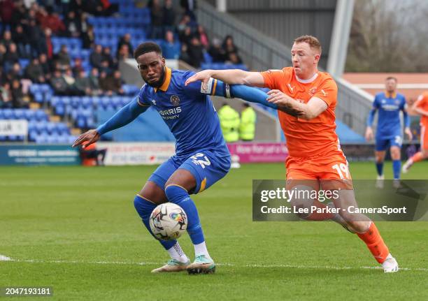 Shrewsbury Town's Cheyenne Dunkley holds off the challenge from Blackpool's Shayne Lavery during the Sky Bet League One match between Shrewsbury Town...