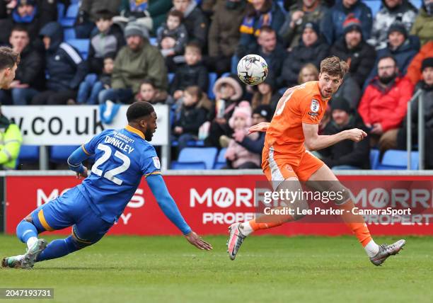 Blackpool's Jake Beesley is tackled by Shrewsbury Town's Cheyenne Dunkley during the Sky Bet League One match between Shrewsbury Town and Blackpool...