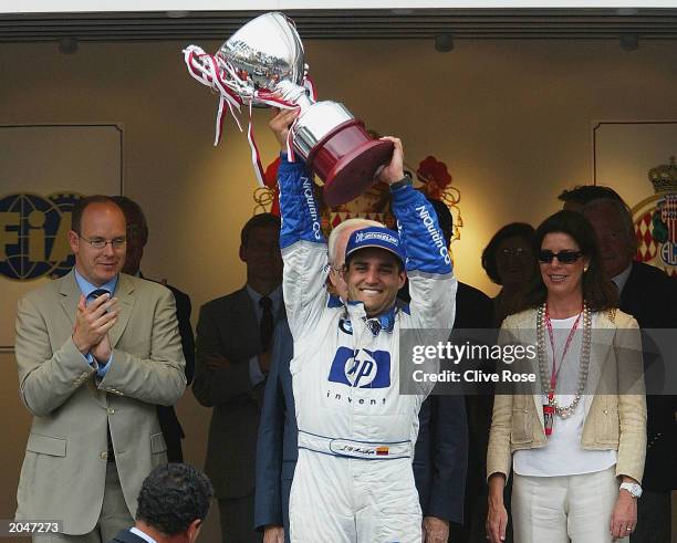 In front of Prince Rainier, Prince Albert and Princess Caroline Juan Pablo Montoya of Colombia and Williams lifts the trophy after winning the...