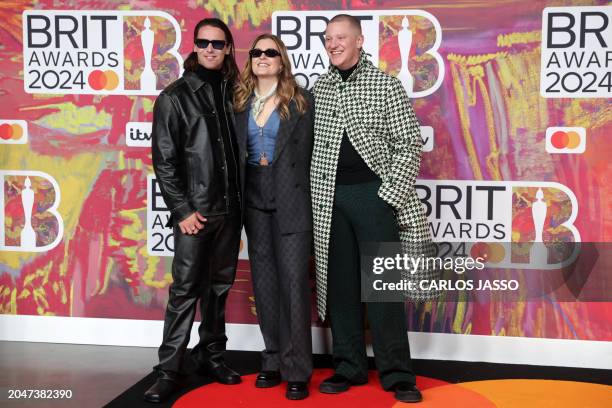Lydia Kitto, Tom McFarland and Josh Lloyd-Watson from British electronic music project Jungle pose on the red carpet upon arrival for the BRIT Awards...