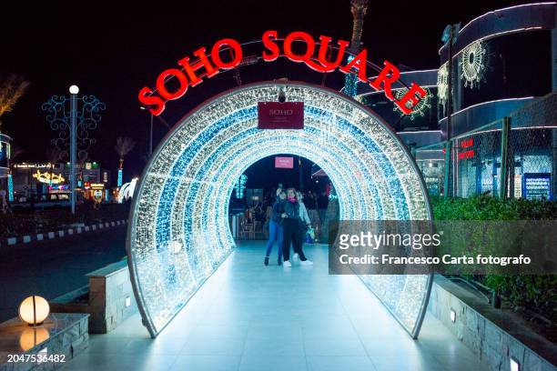 tourists take a selfie inside a tunnel in soho square. sharm el-sheikh, egypt - texture carta stock pictures, royalty-free photos & images