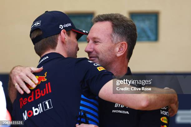 Max Verstappen of the Netherlands and Oracle Red Bull Racing and Oracle Red Bull Racing Team Principal Christian Horner embrace in the Paddock prior...