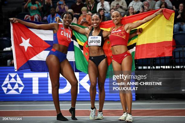 Second-placed Cuba's Leyanis Perez Hernandez, first-placed Dominica's Thea Lafond and third-placed Spain's Ana Peleteiro-compaore celebrate after...