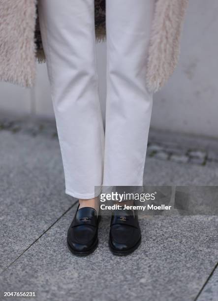 Leo Eberlin seen wearing Marc Cain beige fluffy long coat, & Other Stories white denim straight leg pants / jeans and Chanel black leather loafers,...