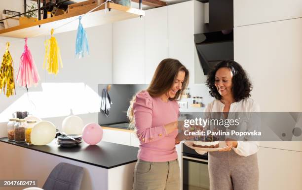 lighting the cake - older woman birthday stock pictures, royalty-free photos & images