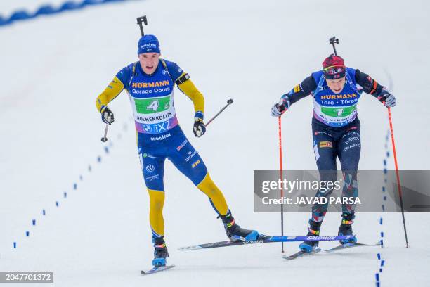 Norway's Vetle Sjastad Christiansen and Sweden's Sebastian Samuelsson sprint to the finish during the single mixed relay event of the IBU Biathlon...