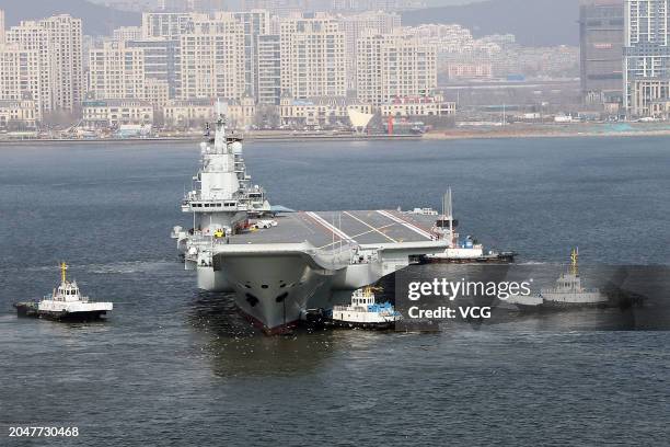 Aircraft carrier Liaoning sets for sea trial at Dalian shipyard with the help of towboats after nearly one year of maintenance on February 29, 2024...