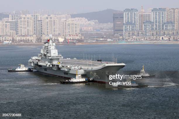 Aircraft carrier Liaoning sets for sea trial at Dalian shipyard with the help of towboats after nearly one year of maintenance on February 29, 2024...