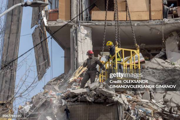 Rescuers clear debris in a multi-story building heavily damaged following a drone strike, in Odesa on March 3 amid the Russian invasion of Ukraine....