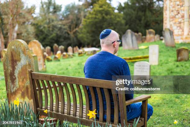 jewish man sitting on bench outside synagogue - mourner stock pictures, royalty-free photos & images