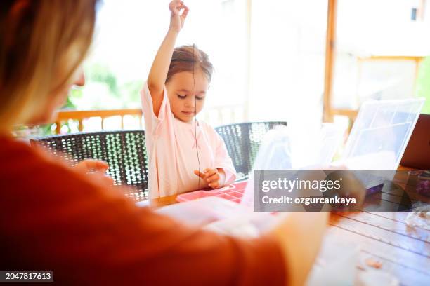 little girl making beaded jewelry at table, closeup - wooden bead stock pictures, royalty-free photos & images