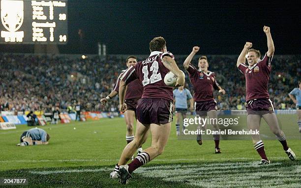 Dane Carlaw of the Maroons celebrates with team mates after scoring the series winning try during game 3 of the NRL State of Origin series between...