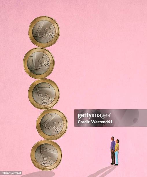 two people looking at unstable column of oversized one euro coins - ersparnisse stock-grafiken, -clipart, -cartoons und -symbole