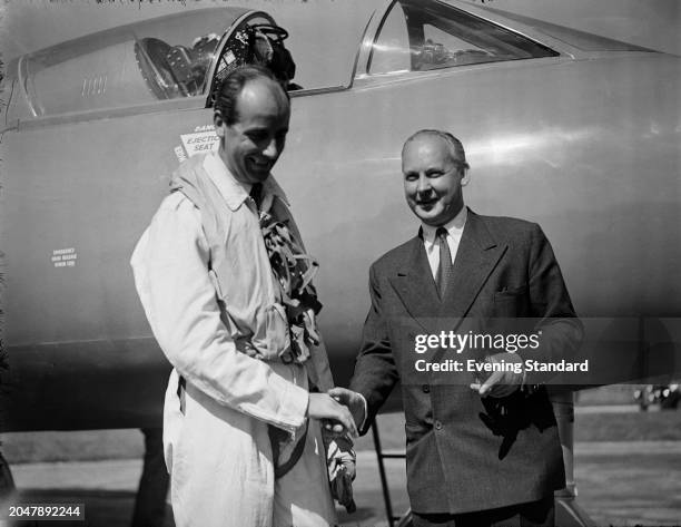 British test pilot Neville Duke shaking hands with an unidentified man at RAF Tangmere in West Sussex, September 7th 1953. Duke had just set a new...
