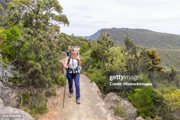 young woman hiking in tasmania, australia - hiking tasmania stock-fotos und bilder