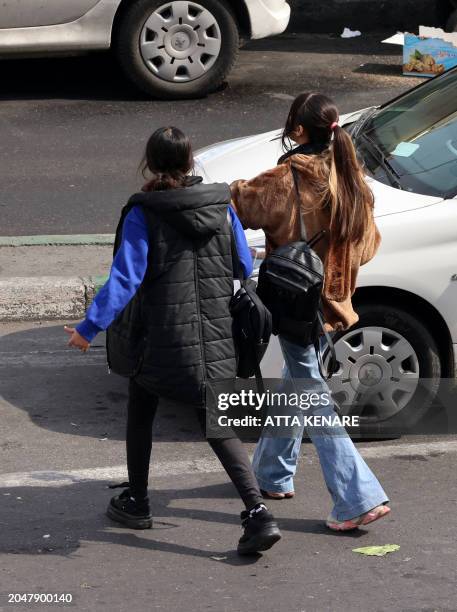 Women walk in a street in Tehran on March 3 two days after Iranians voted in the country's parliamentary election. Iran began counting ballots on...