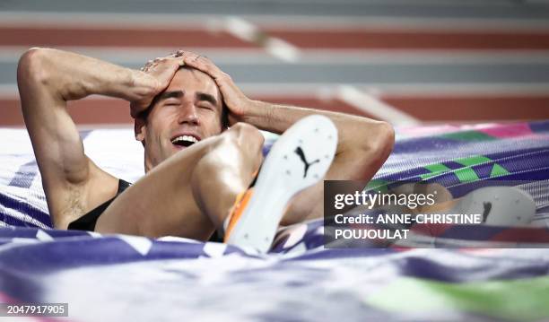 First-placed New Zeland's Hamish Kerr celebrates after winning the Men's High Jump final during the Indoor World Athletics Championships in Glasgow,...