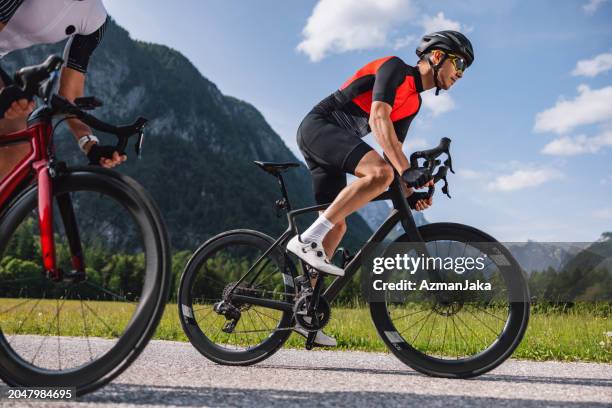 deportista caucásico masculino en bicicleta de carretera junto con su amiga en el campo - ciclismo en ruta fotografías e imágenes de stock