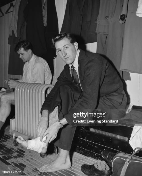Tottenham Hotspur Football Club midfielder Tony Marchi taping his foot in a locker room, London, March 8th 1956.