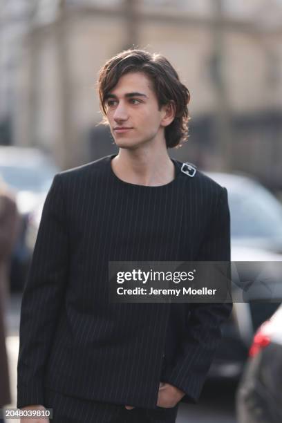 Sebastian Croft was seen wearing a black top with little white stripes before Courreges Fashion Show during the Womenswear Fall/Winter 2024/2025 as...