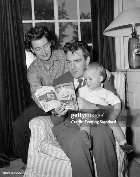 Journalist and author John Seymour Chaloner with his wife, reading to his son Nicholas, November 7th 1956.