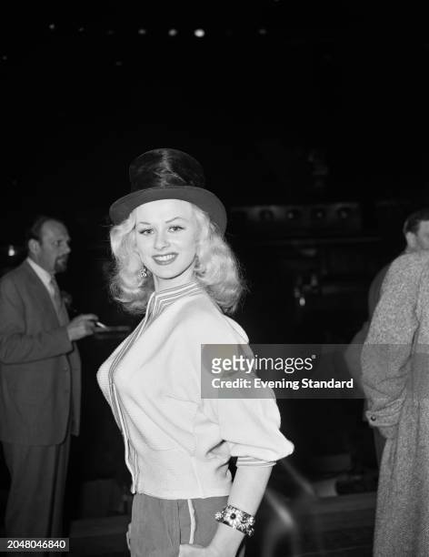 Actress and glamour model Sabrina wearing a top hat, November 7th 1956.