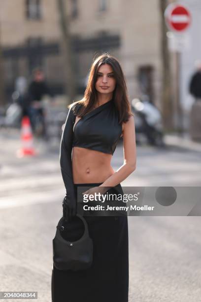 Emily Ratajkowski was seen wearing a long black skirt, a belly free black top as well as a black courreges bag before Courreges Fashion Show during...