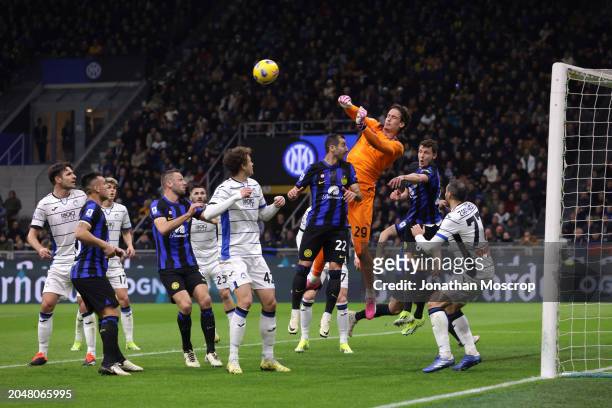 Marco Carnesecchi of Atalanta leaps to punch the ball clear from the head of Henrikh Mkhitaryan of FC Internazionale during the Serie A TIM match...