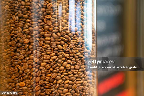 roasted coffee beans in a glass jar - roma capucino stock pictures, royalty-free photos & images