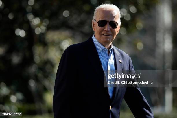 President Joe Biden walks across the South Lawn before boarding the Marine One presidential helicopter and departing the White House on February 29,...