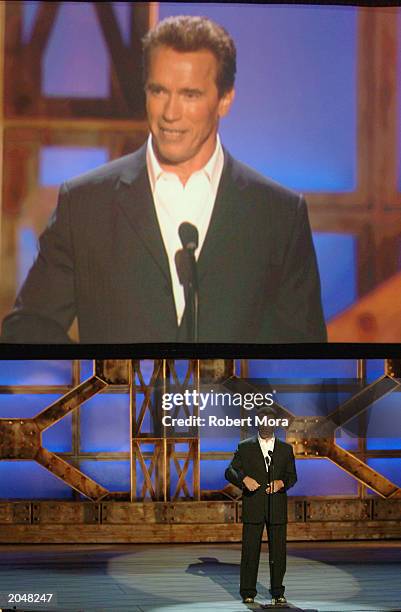 Actor Arnold Schwarzenegger presents the Taurus Honorary Lifetime Achievement Award on stage during the 3rd Annual Taurus World Stunt Awards at...