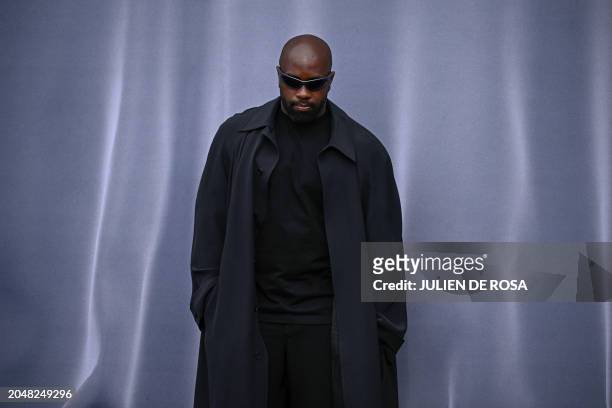 French judoka Teddy Riner poses as he arrives for the presentation of creations by Balenciaga for the Women Ready-to-wear Fall-Winter 2024/2025...