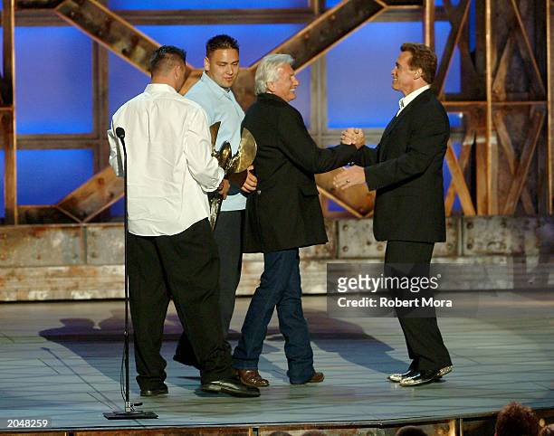 Actor Arnold Schwarzenegger presents the Taurus Honorary Lifetime Achievement Award to director/stuntman/stunt coordinator Terry Leonard accompanied...