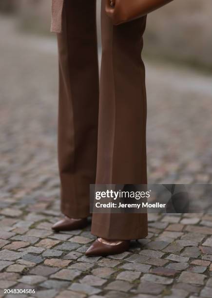 Leo Eberlin seen wearing Zara brown suit pants and Christian Louboutin brown leather heels / pumps, on February 25, 2024 in Berlin, Germany.