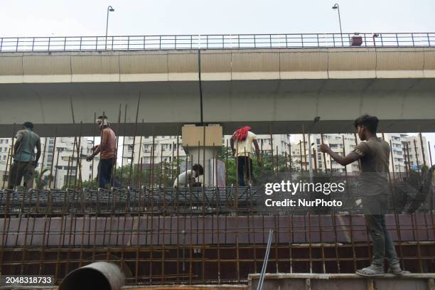 Workers are erecting scaffolding at a construction site in Kolkata, India, on March 3, 2024.