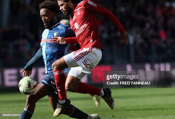 Brest's French midfielder Mahdi Camara fights for the ball with Le Havre's French defender Yoann Salmier during the French L1 football match between...