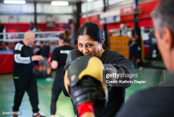 female boxer practicing with trainer - self defense class stock pictures, royalty-free photos & images