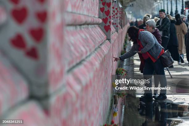 People gather at the National Memorial Wall to commemorate everyone who died during the Covid-19 pandemic on the first annual day of reflection in...