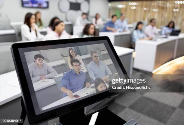 mba student talking in class in a modern classroom - facial recognition technology stock pictures, royalty-free photos & images