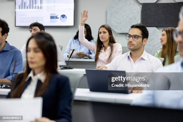 mba student asking a question in class - master of business administration stock pictures, royalty-free photos & images