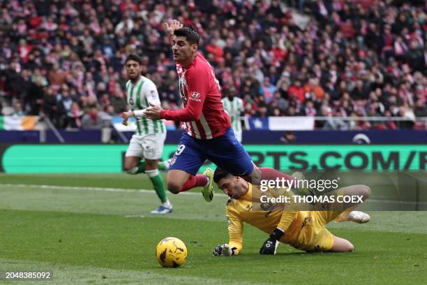 Atletico Madrid's Spanish forward Alvaro Morata vies with Real Betis' Portuguese goalkeeper Rui Silva during the Spanish league football match...