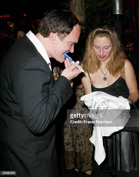 Director Quentin Tarantino signs an autograph for a fan during the after party for the 3rd Annual Taurus World Stunt Awards at Paramount Studios June...