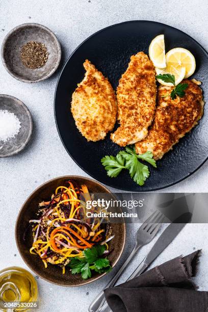chicken schnitzel and julienne strips of purple, yellow, orange, white carrots salad - chicken strip stock pictures, royalty-free photos & images