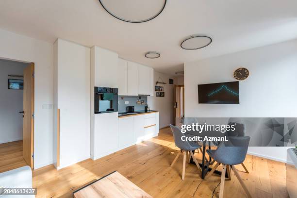 modern apartment interior with sleek kitchen and dining area - vip room stock pictures, royalty-free photos & images