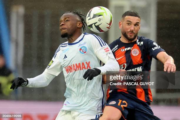 Montpellier's French midfielder Jordan Ferri fights for the ball with Strasbourg's French defender Junior Mwanga during the French L1 football match...