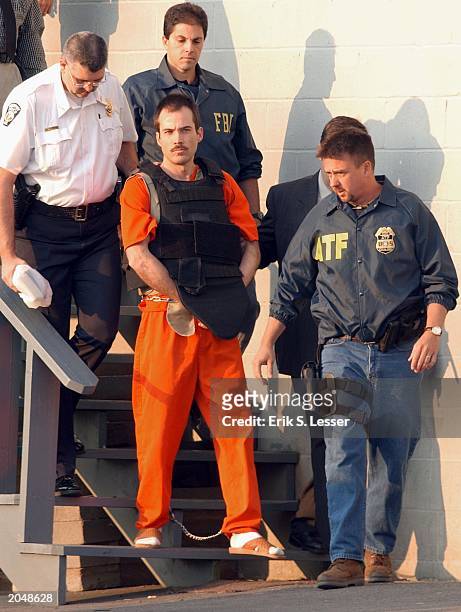 Multiple bombing suspect Eric Robert Rudolph, center, is escorted by law enforcement officials from the Cherokee County Courthouse and Jail in...